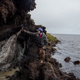 Ryan Cody, a GIS Analyst in Dr. Tweedie’s labratory at the Univeristy of Texas at El Paso (UTEP), touches a block of ice wedged against the permafrost coastline of Utqiaġvik. When big pieces of ice break away, they can tear a part of the coast away with them. Cody says that he and his team check this location twice a year to measure its recession. Photo: Ash Adams/Gizmodo